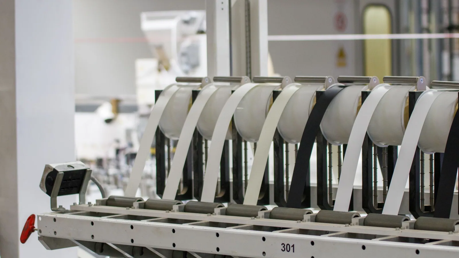A bank of component feeders loaded onto a surface mount assembly machine, tape reels queued at each station.